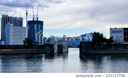 Tokyo Waterfront Gate and High Rise Construction across Calm Water Tokyo Waterfront Gate and High Rise Construction across Calm Water 143117706