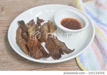fried crispy salty fermenting beef fat meat with pepper on plate dipping Thai spicy chili sauce fried crispy salty fermenting beef fat meat with pepper on plate dipping Thai spicy chili sauce 143118358