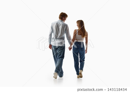 Rear view of young couple walking away together on white background Rear view of young couple walking away together on white background 143118434