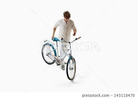 Young cyclist inspects bicycle handlebars before riding Young cyclist inspects bicycle handlebars before riding 143118470