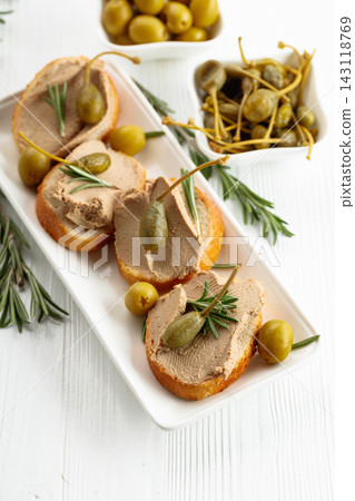 Sandwiches with pate on a white wooden table. Sandwiches with pate on a white wooden table. 143118769