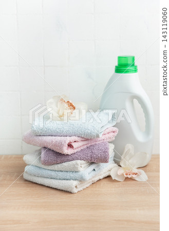 Stack of clean towels with laundry detergent bottle Stack of clean towels with laundry detergent bottle 143119060