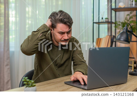 Middle-aged man frowning laptop frustrated by error bad news virus warning stressful work at table Middle-aged man frowning laptop frustrated by error bad news virus warning stressful work at table 143121168