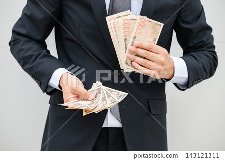 Businessman with a bundle Businessman with a bundle 143121311
