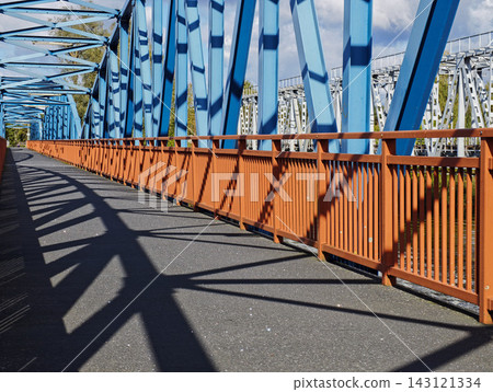 Pedestrian and Cycling Bridge with Blue Steel and Orange Railings Pedestrian and Cycling Bridge with Blue Steel and Orange Railings 143121334