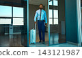 Businessman walks through airport entrance pulling a suitcase with composed determination Businessman walks through airport entrance pulling a suitcase with composed determination 143121987