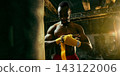 Serious boxer wraps his hands beside a heavy bag with calm preparation Serious boxer wraps his hands beside a heavy bag with calm preparation 143122006