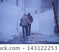 People walking on snowy roads 143122253