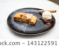 Apple strudel with vanilla ice cream and chocolate shavings in Tienen Apple strudel with vanilla ice cream and chocolate shavings in Tienen 143122591