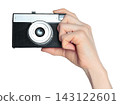 Hand holding retro photo camera isolated on transparent background, front view, retro things concept 143122601