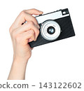 Hand holding retro photo camera isolated on transparent background, front view, retro things concept 143122602