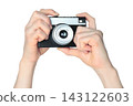 Hand holding retro photo camera isolated on transparent background, front view, retro things concept 143122603