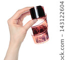 Hand holding photographic film for a retro photo camera, isolated on transparent background. Retro technology and nostalgia concept 143122604