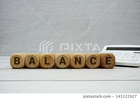 BALANCE alphabet letters with calculator on wooden background BALANCE alphabet letters with calculator on wooden background 143122927