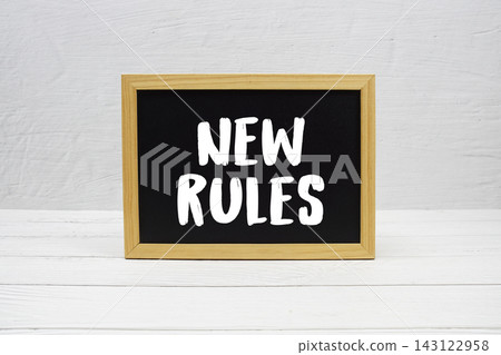 New Rules text written on blackboard 143122958