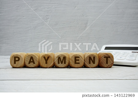 PAYMEN alphabet letters with calculator on wooden background PAYMEN alphabet letters with calculator on wooden background 143122969