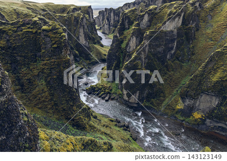 Fjadrargljufur canyon and Fjadra River beneath mossy cliffs in South Iceland Fjadrargljufur canyon and Fjadra River beneath mossy cliffs in South Iceland 143123149