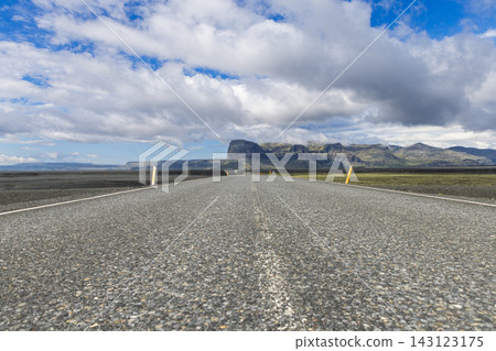 Low view along Iceland Route 1 toward Lomagnupur across black sand plain Low view along Iceland Route 1 toward Lomagnupur across black sand plain 143123175