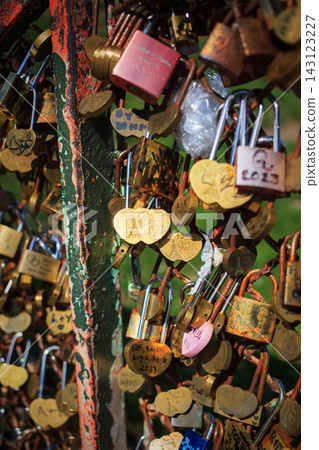 Souvenir padlocks hung by tourists on a fence in Montmartre, Paris, France Souvenir padlocks hung by tourists on a fence in Montmartre, Paris, France 143123227