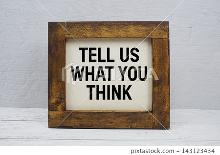 Tell Us What You Think text written on wooden board Tell Us What You Think text written on wooden board 143123434
