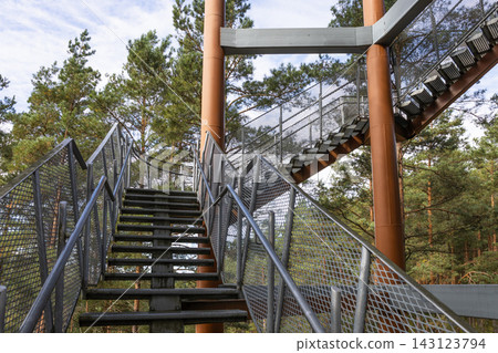 Metal staircase of an observation tower in the forest Metal staircase of an observation tower in the forest 143123794