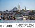 Istanbul,turkey,august 4, 2025. Istanbul's historic suleymaniye mosque and surrounding buildings rise above the bosphorus, with tour boats navigating the waterway 143123829