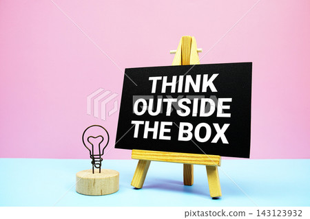 Think Outside The Box text written on wooden easel stand Think Outside The Box text written on wooden easel stand 143123932
