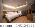 Modern and Cozy Hotel Room Interior with Twin Beds and Warm Lighting 143124111