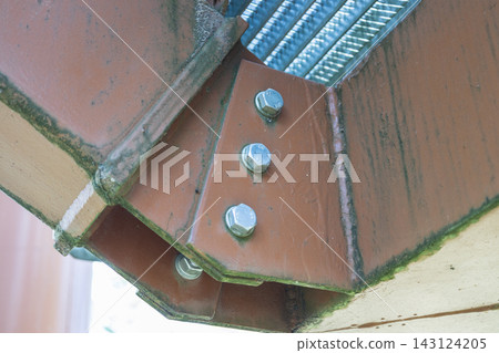 Close-up of structural steel connection joint with bolts and welds Close-up of structural steel connection joint with bolts and welds 143124205