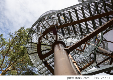 Winding metal staircase of an outdoor observation tower rising into the sky Winding metal staircase of an outdoor observation tower rising into the sky 143124385
