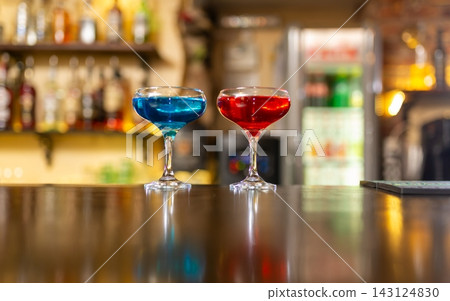 Two cocktails on wooden bar counter closeup Two cocktails on wooden bar counter closeup 143124830