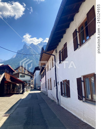 Dramatic architectural view of alpine houses and mountain peak in Mittenwald, Bavaria, Germany Dramatic architectural view of alpine houses and mountain peak in Mittenwald, Bavaria, Germany 143124935