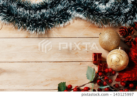 Rustic Christmas background featuring a decorative frame surrounding a large open space for text, set on a light wood table. Rustic Christmas background featuring a decorative frame surrounding a large open space for text, set on a light wood table. 143125997