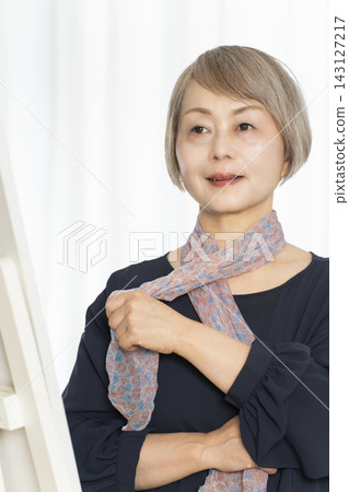 Senior women choosing scarves to dress stylishly Senior women choosing scarves to dress stylishly 143127217
