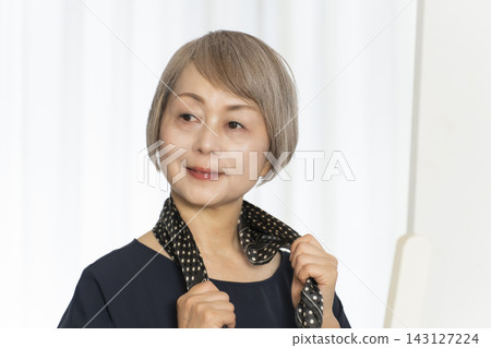 Senior women choosing scarves to dress stylishly Senior women choosing scarves to dress stylishly 143127224