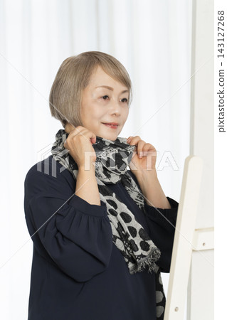 Senior women choosing scarves to dress stylishly Senior women choosing scarves to dress stylishly 143127268