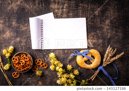 Oktoberfest background with brezel, hops and malt Oktoberfest background with brezel, hops and malt 143127386