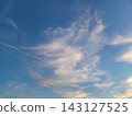 A crescent moon and contrails in the sunset sky 143127525