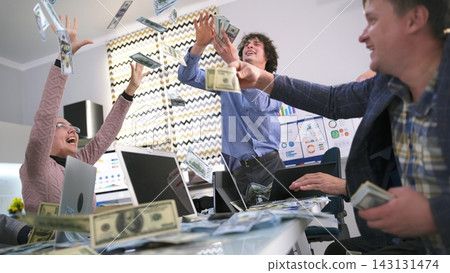 A group of economists are catching money falling from top to bottom. People are celebrating, and money is flying around them. Business and finance A group of economists are catching money falling from top to bottom. People are celebrating, and money is flying around them. Business and finance 143131474