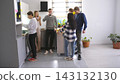 A group of guys and young women on a coffee break in the office kitchen. Take a break from work in a cozy family office 143132130