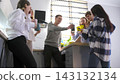Happy guys and women of the company clink glasses of coffee, celebrating their professional holiday. Several students 143132134