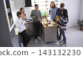 Coffee break at work. The scene is relaxed and social, as a group of friends enjoy each other's company, sharing food and drinks 143132230