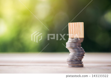 Coins stacked high on the table and Wooden blocks that can be put symbols high risk concept of financial business. Coins stacked high on the table and Wooden blocks that can be put symbols high risk concept of financial business. 143133322