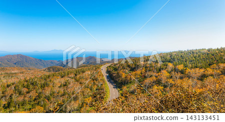 A view from Shiretoko Pass overlooking a calm autumn blue sky, colorful foliage, and the Northern Territories. A view from Shiretoko Pass overlooking a calm autumn blue sky, colorful foliage, and the Northern Territories. 143133451
