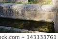 Old stone channel flowing with clear water. Nacimiento rio Arandilla 143133761