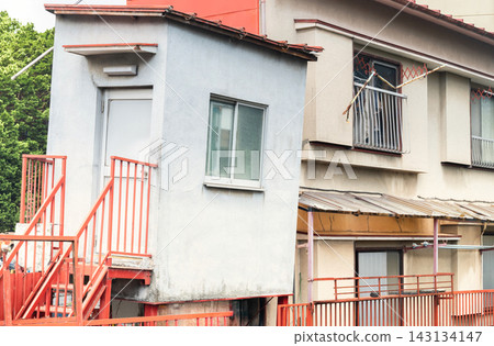 An apartment building where the added section is on the verge of collapsing. An apartment building where the added section is on the verge of collapsing. 143134147
