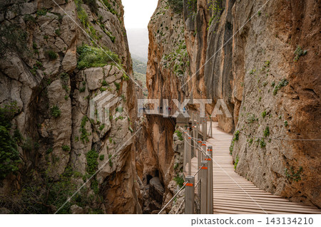 ooden boardwalk clinging to sheer canyon walls at Caminito del Rey, Spain ooden boardwalk clinging to sheer canyon walls at Caminito del Rey, Spain 143134210