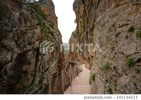 ooden boardwalk clinging to sheer canyon walls at Caminito del Rey, Spain ooden boardwalk clinging to sheer canyon walls at Caminito del Rey, Spain 143134213