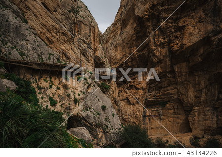 Elevated wooden boardwalk bolted to a sheer canyon wall at Caminito del Rey, Spain Elevated wooden boardwalk bolted to a sheer canyon wall at Caminito del Rey, Spain 143134226