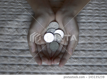 Russian coins in women's hands. payment purchases, utility bills or bank loans Russian coins in women's hands. payment purchases, utility bills or bank loans 143135239
